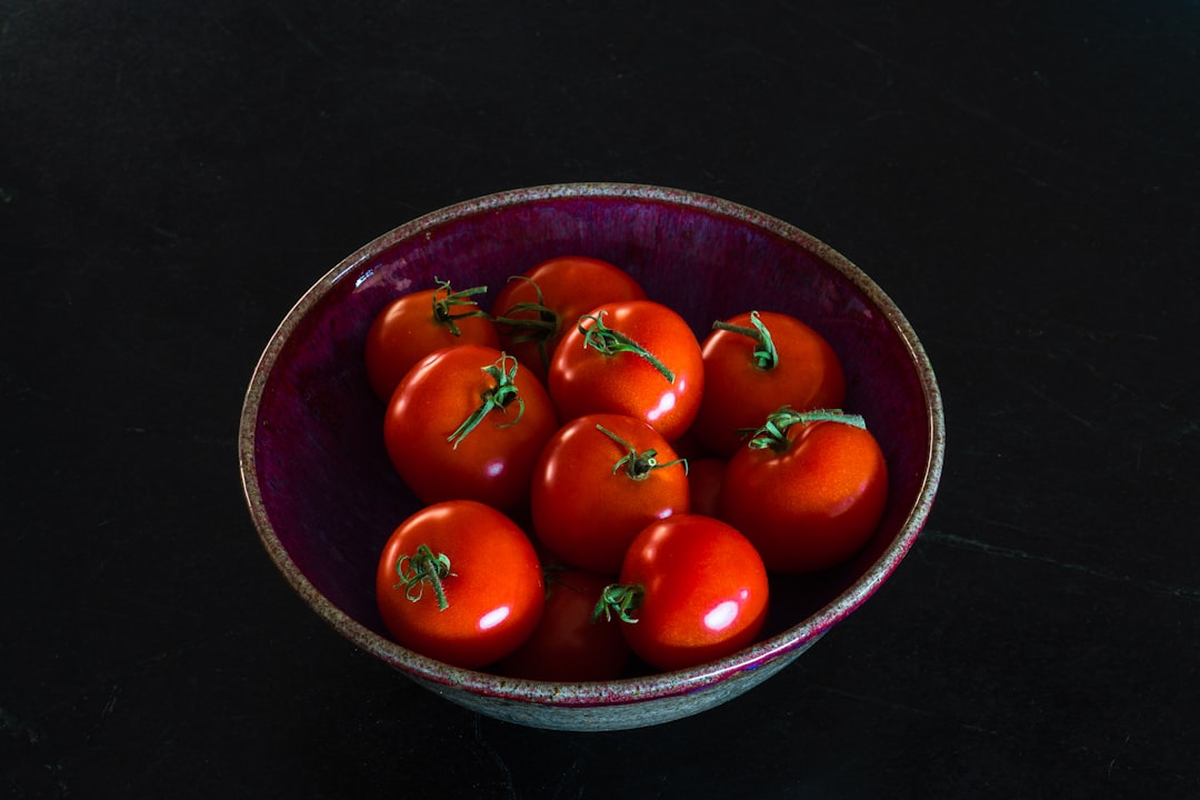 red tomatoes in blue ceramic bowl