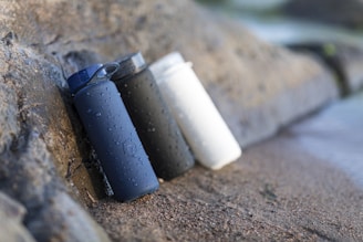 black and white plastic containers on brown sand