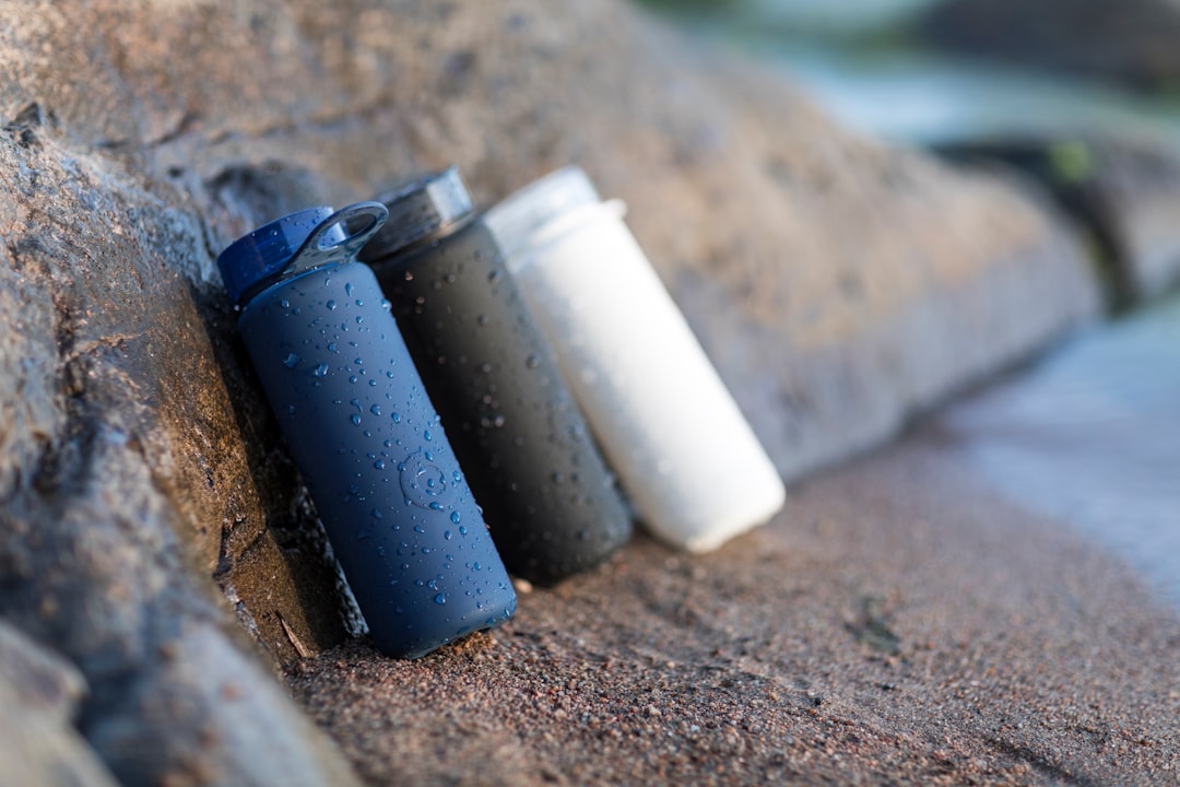 black and white plastic containers on brown sand