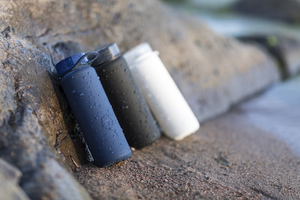 black and white plastic containers on brown sand