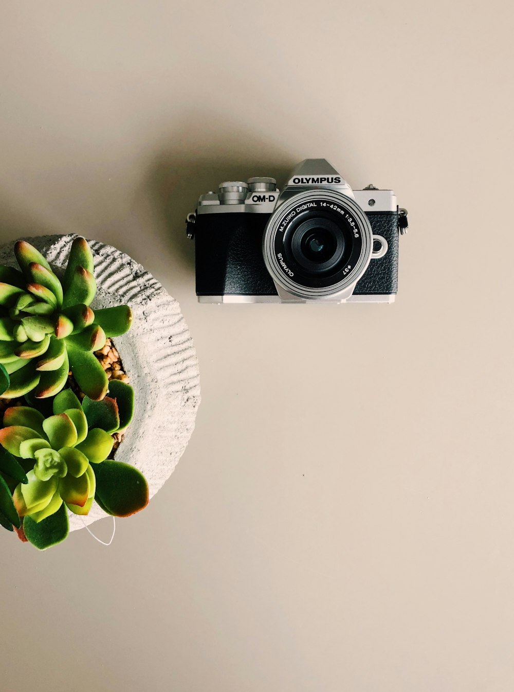 black and silver dslr camera on white round table