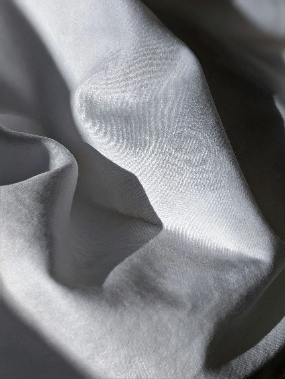 white textile on brown wooden table