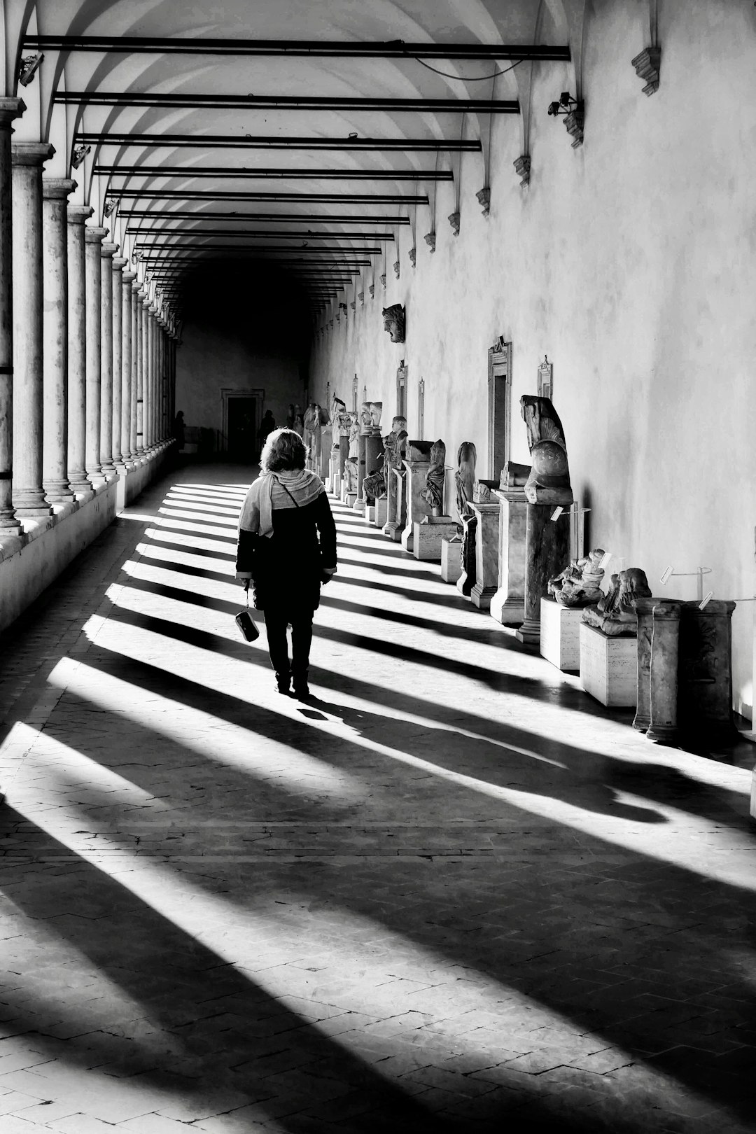 man in black jacket walking on hallway