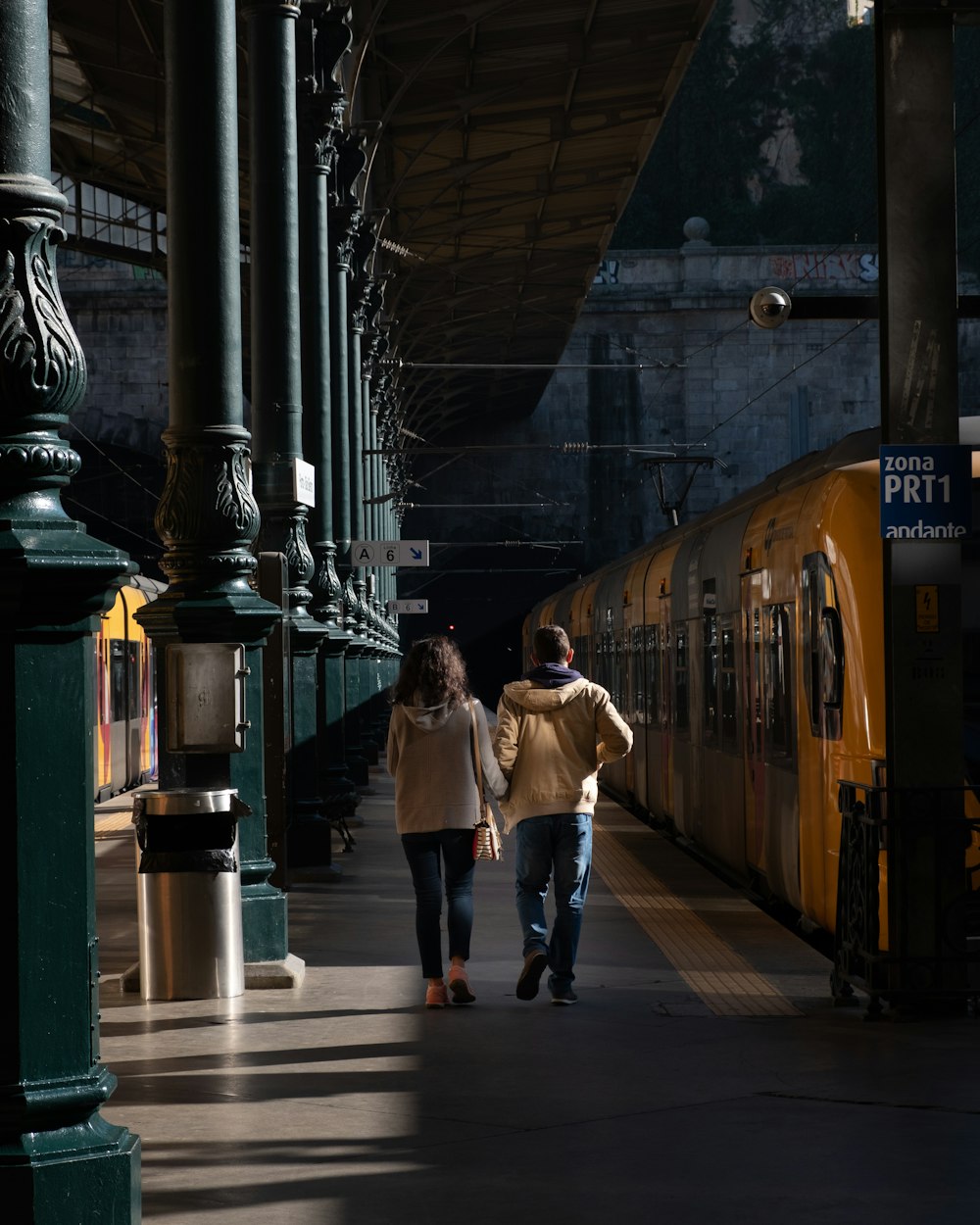 man and woman walking on train station