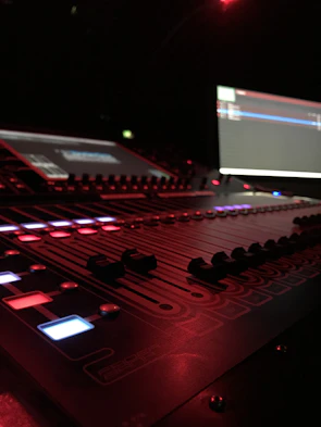 Close-up of professional sound equipment setup with glowing LED lights during an event.