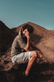 A researcher examining climate data charts outdoors in a desert environment.