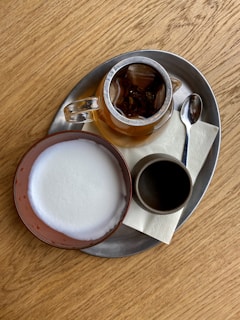 white ceramic mug on brown wooden table