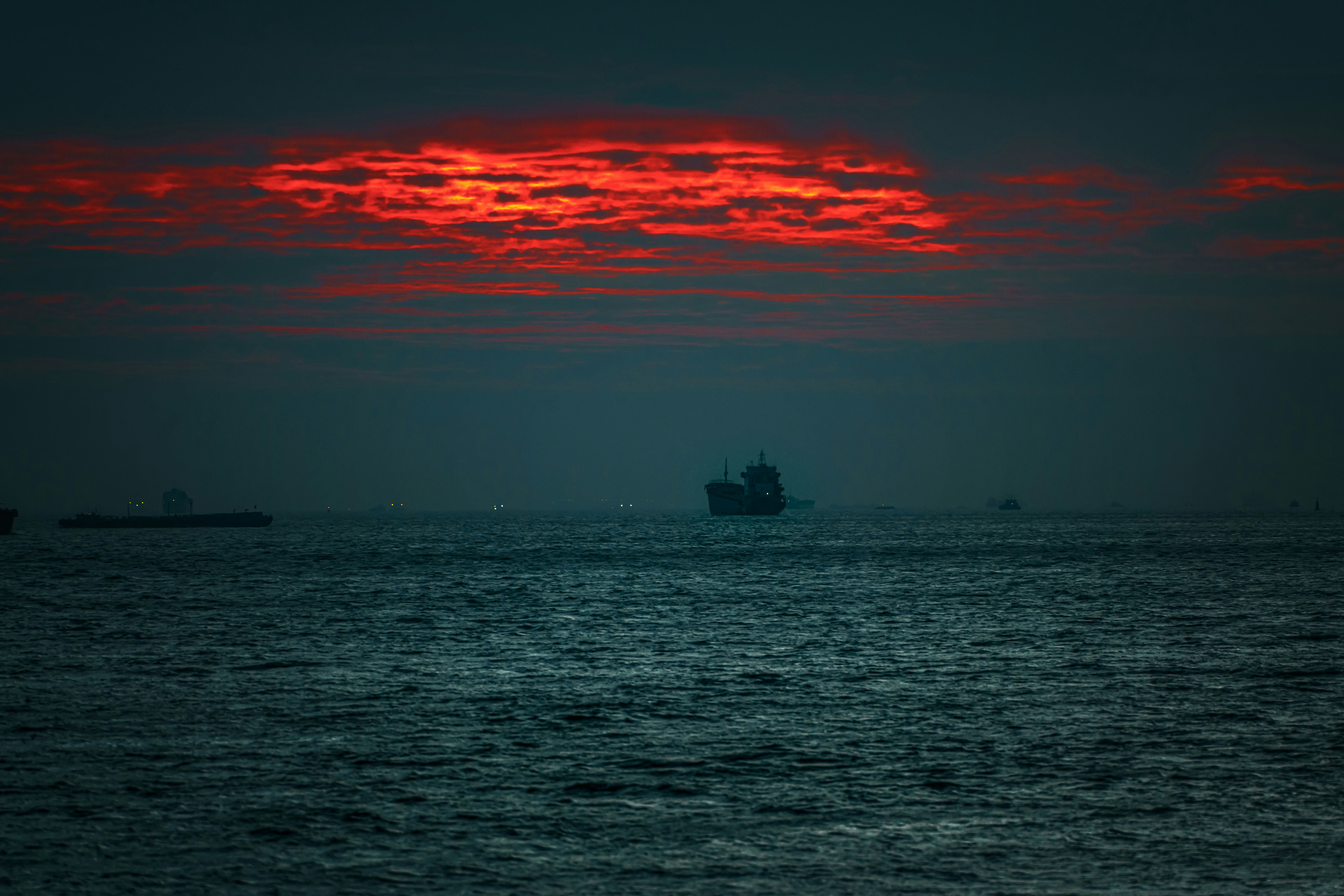 silhouette of boat on sea during sunset