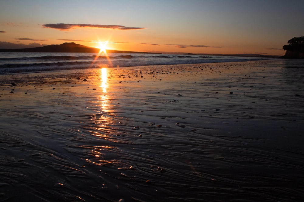 body of water during sunset