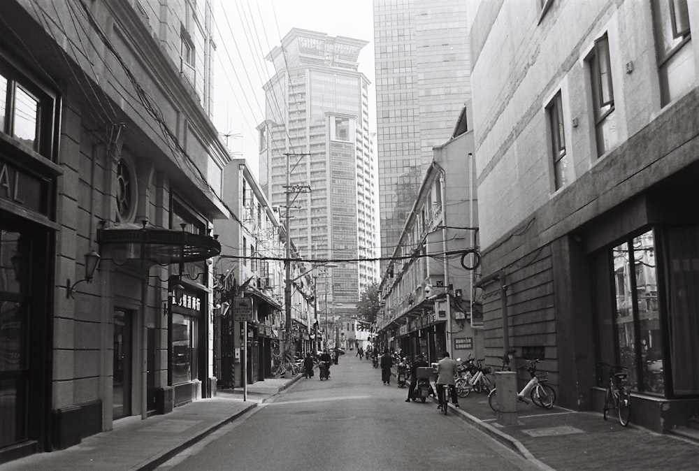 people walking on sidewalk near buildings during daytime