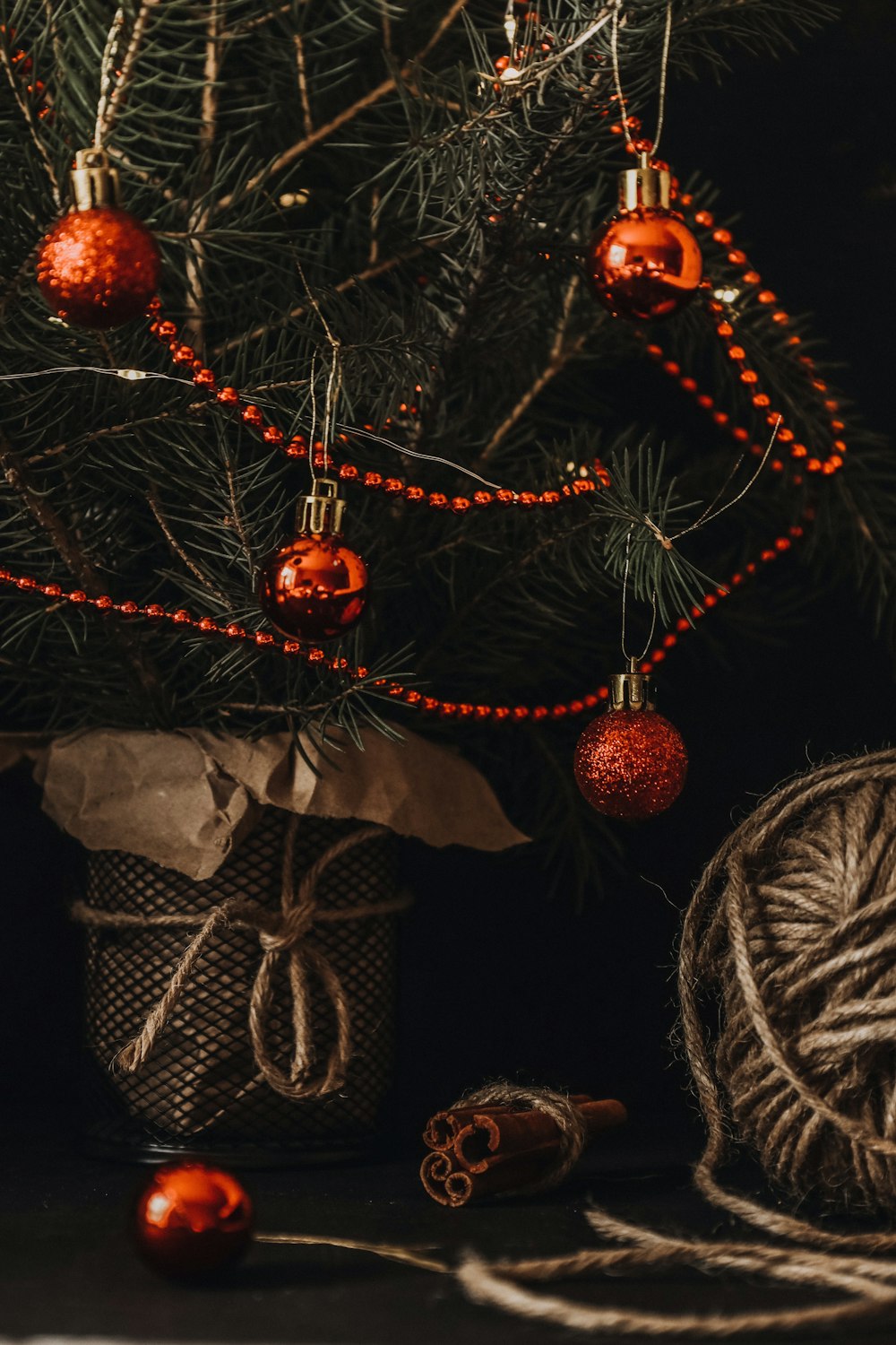 brown and gray pine cone with brown and white ribbon