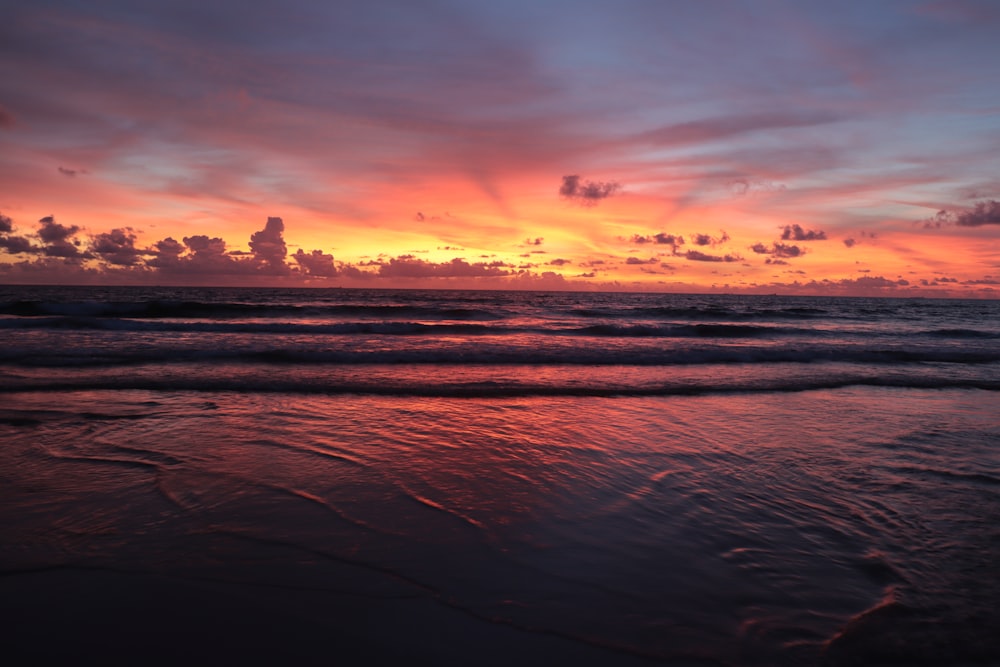 body of water during sunset