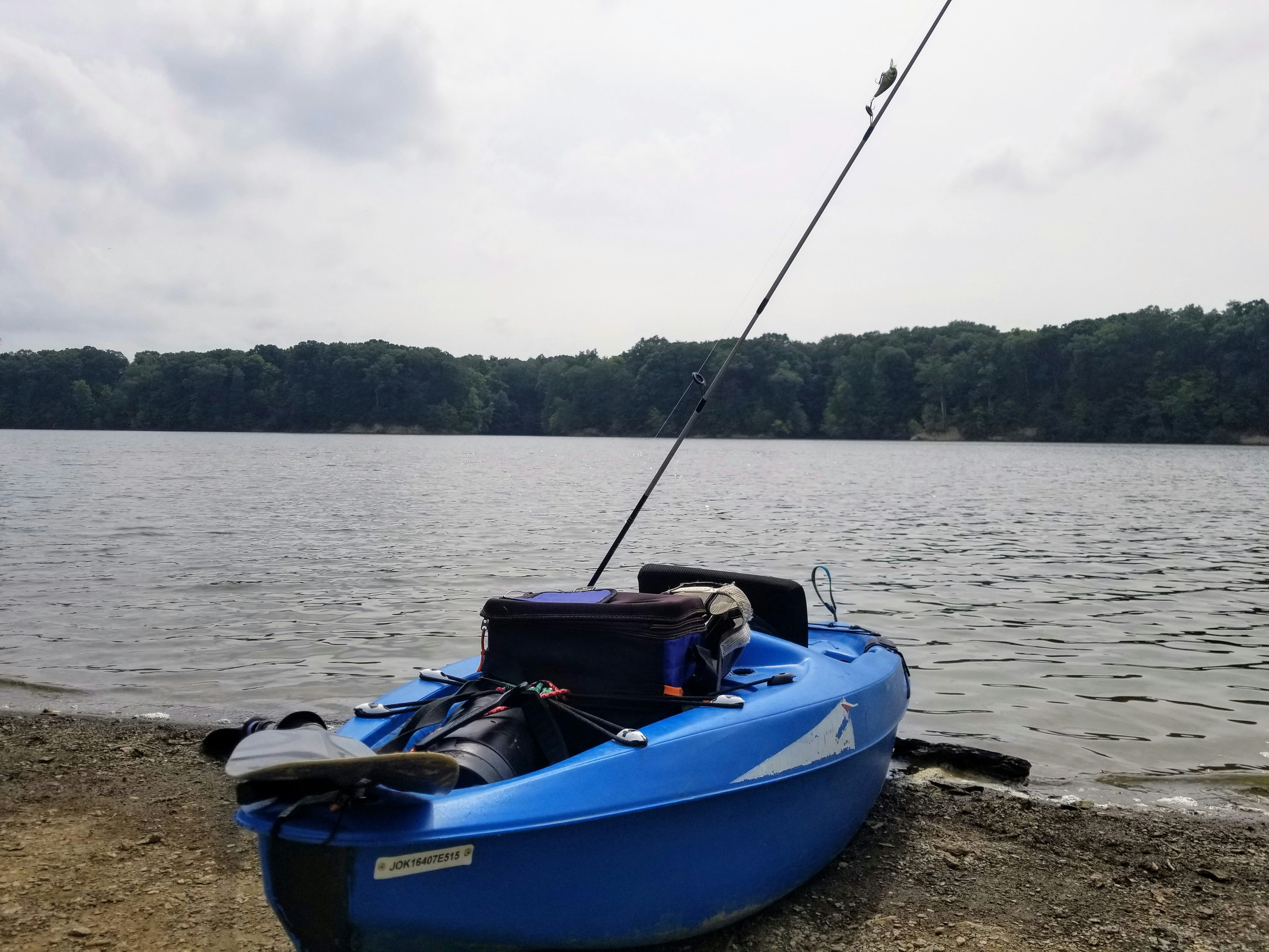blue and white kayak on shore during daytime, 