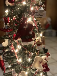 red and gold christmas tree with baubles and string lights