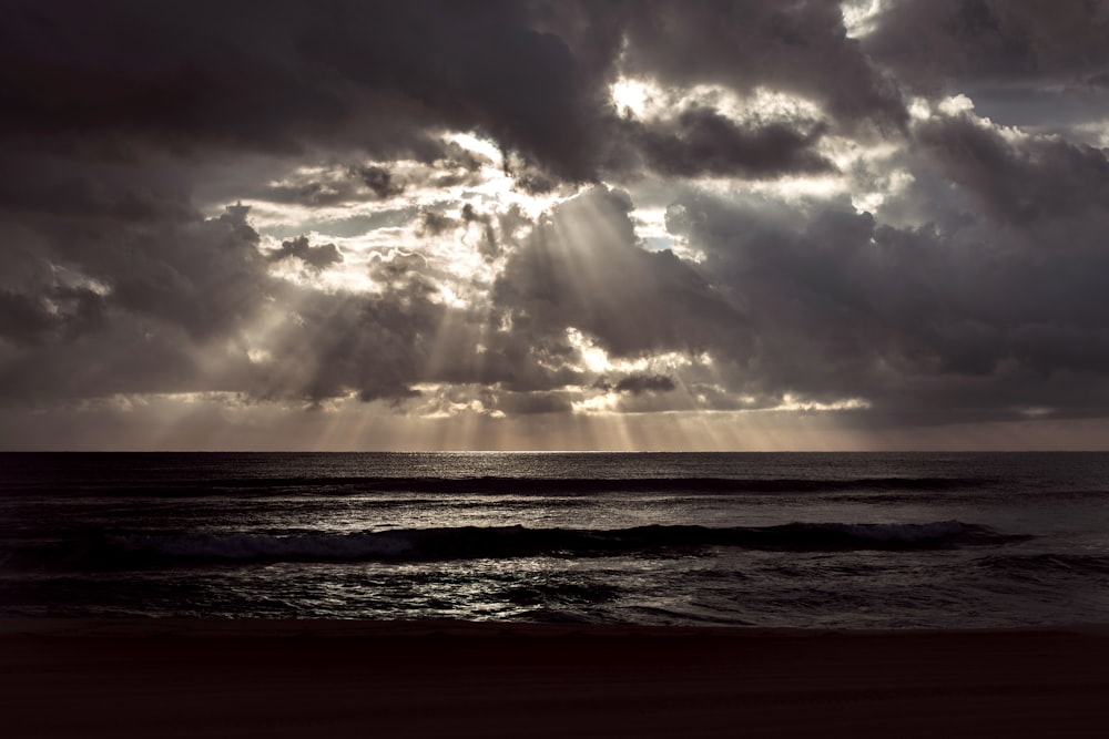 ocean waves under cloudy sky during daytime