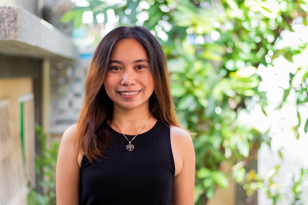 woman in black tank top smiling