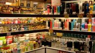 assorted bottles on glass shelf