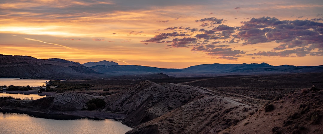 brown mountains under orange sky during sunset