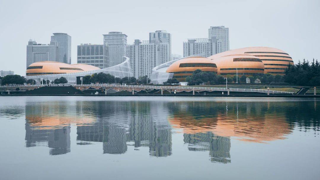 white and brown building near body of water during daytime