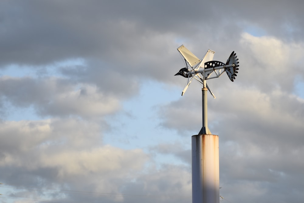 white and black wind turbine under white clouds during daytime