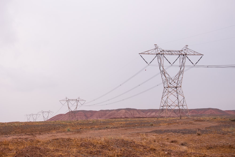 black and white wind mill on brown field under white sky during daytime