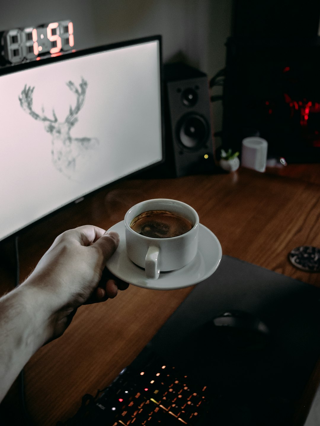 person holding white ceramic mug with brown liquid