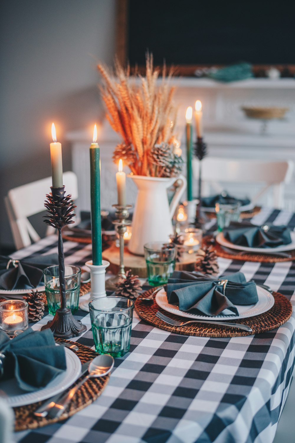 white candles on white and blue checkered table cloth