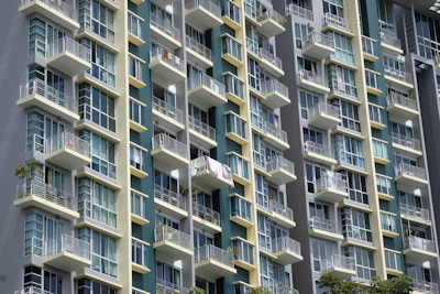 A modern residential building with large windows and balconies.