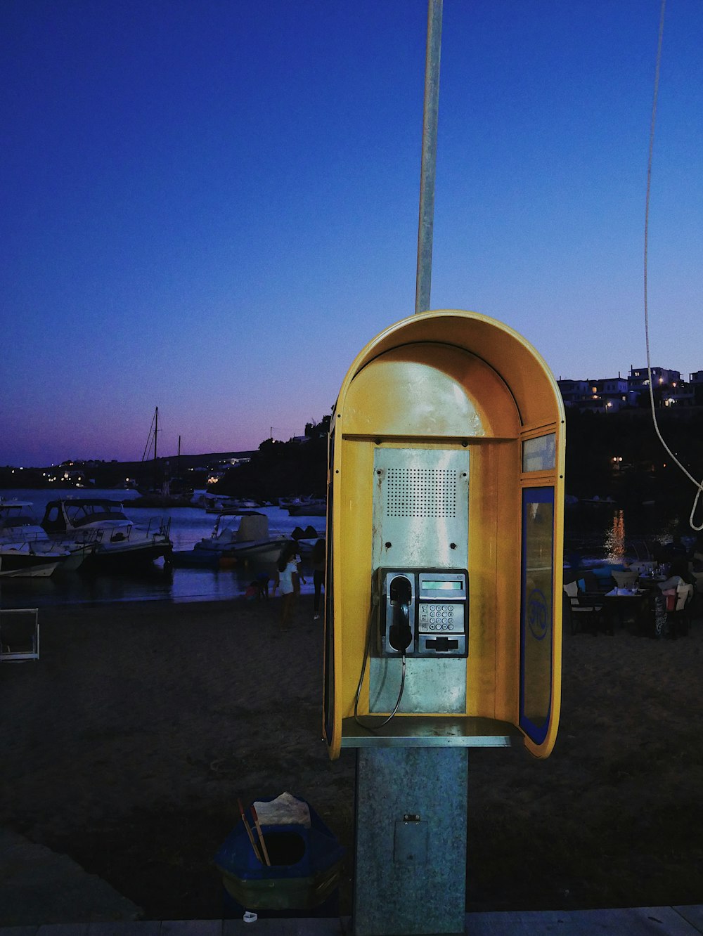 yellow and silver telephone booth