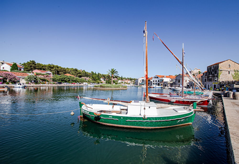 red and white boat on water during daytime