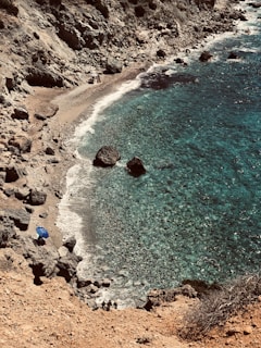 Idyllic Italian island landscape, crystal-clear turquoise waters lapping against sun-kissed rocky 