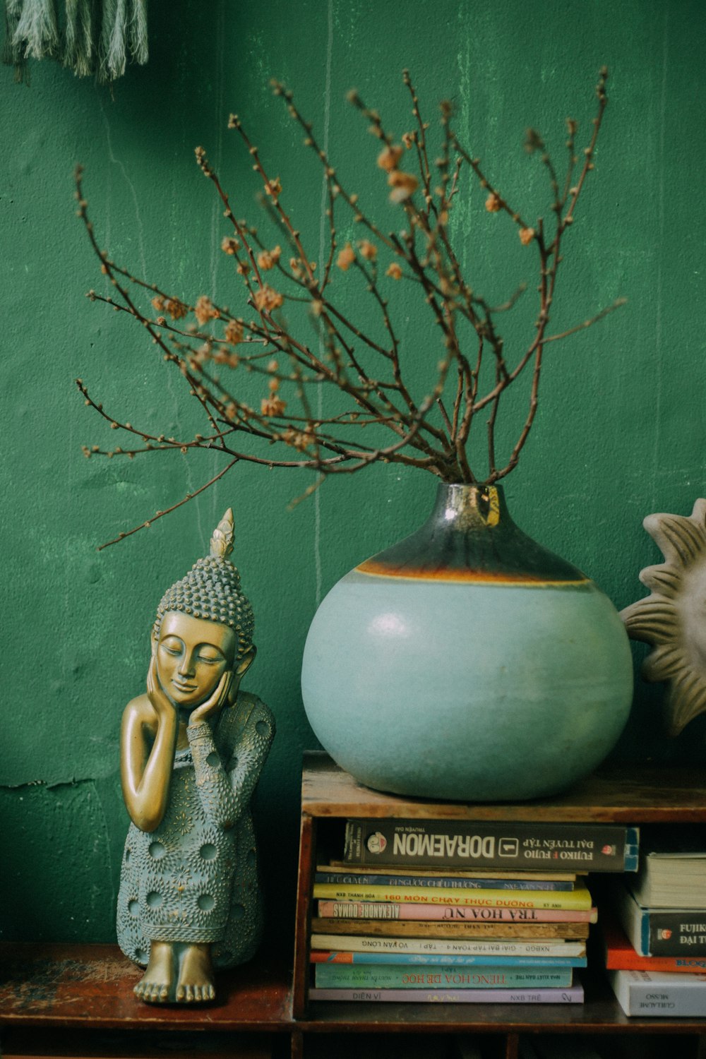 gold and white ceramic vase on brown wooden table