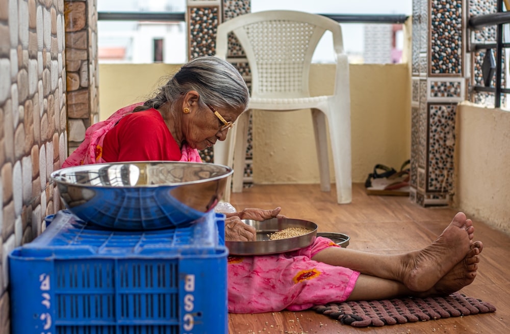 woman in red shirt sitting on floor