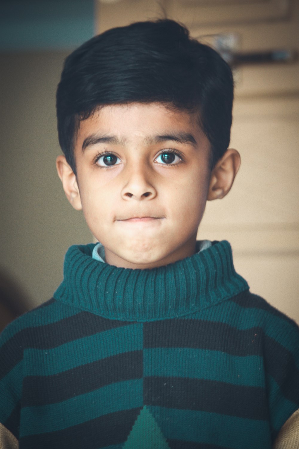 boy in blue and black striped sweater