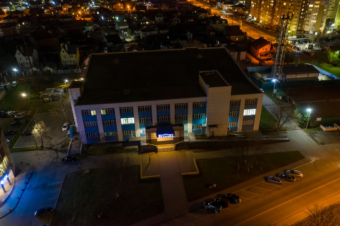 cars parked in front of building during night time