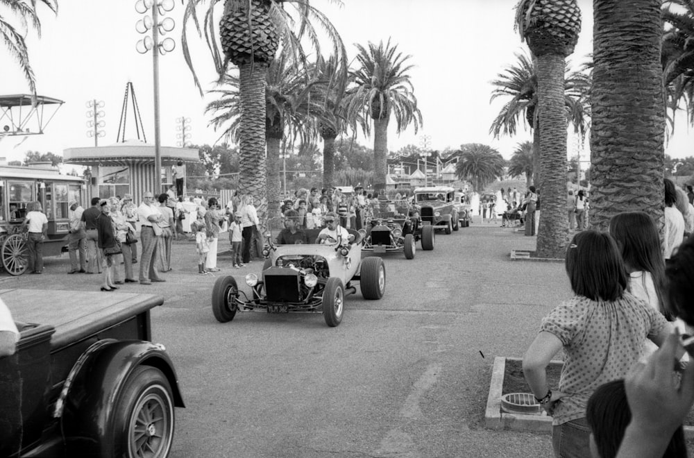 grayscale photo of vintage car on road