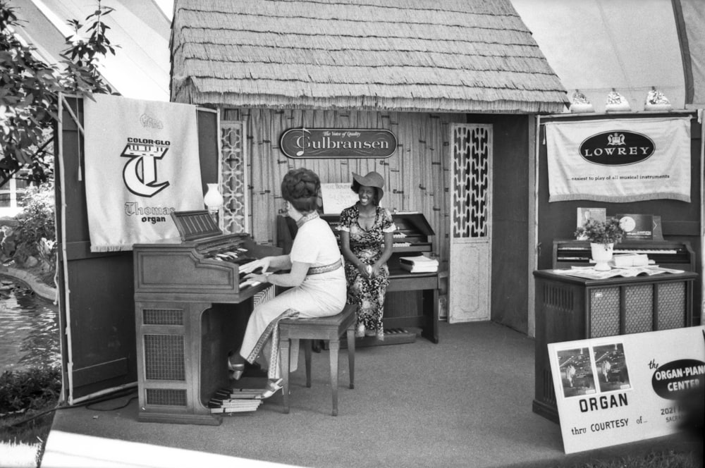 grayscale photo of 2 men playing piano