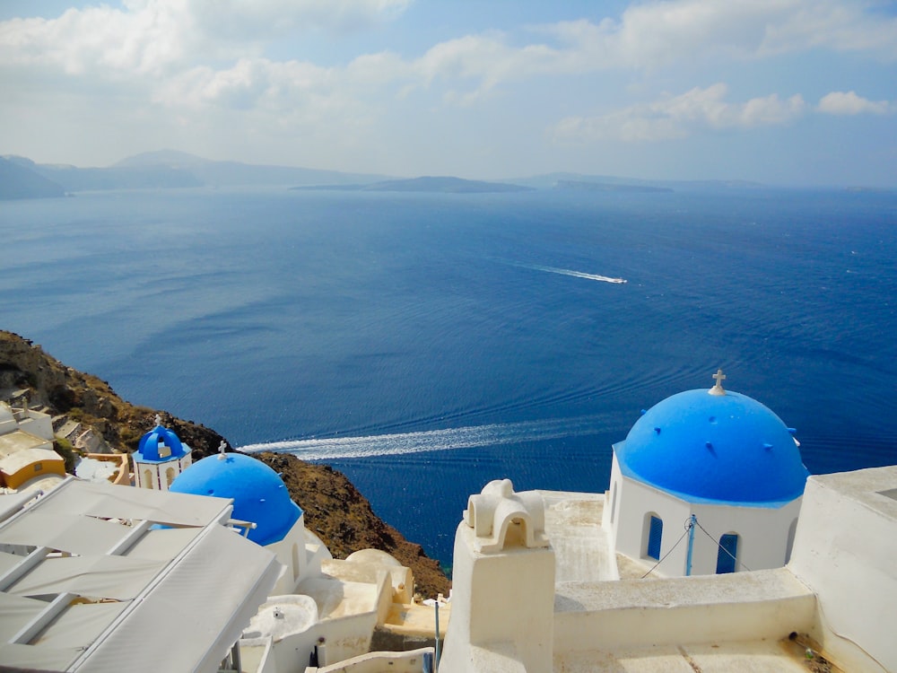 white and blue dome building on top of mountain during daytime