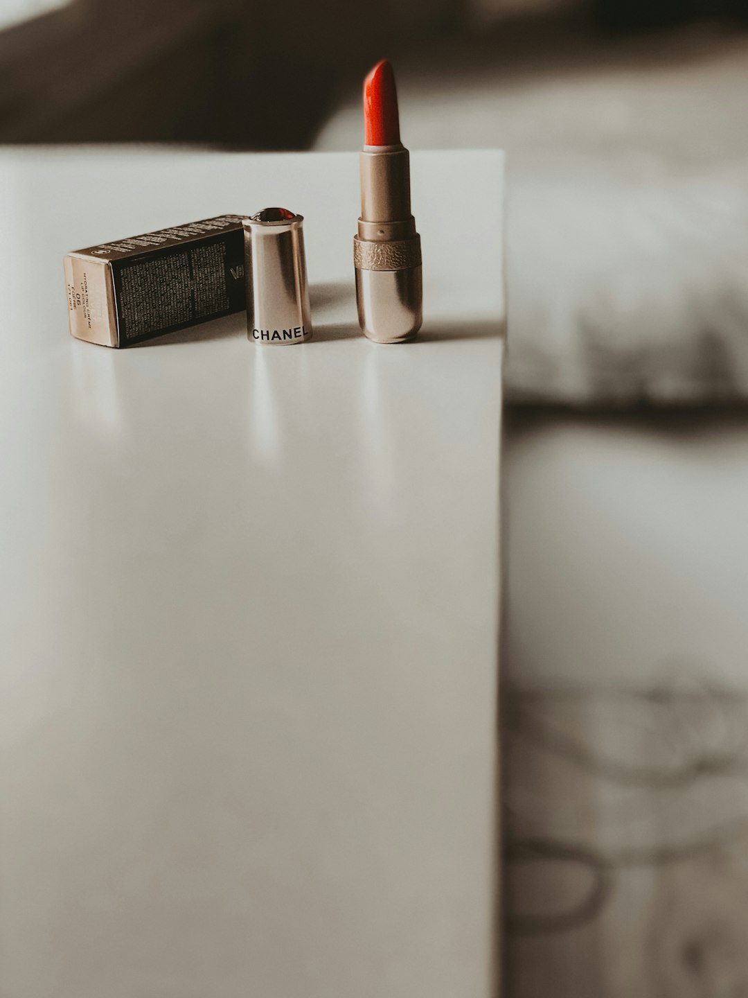 brown and silver lipstick on white table