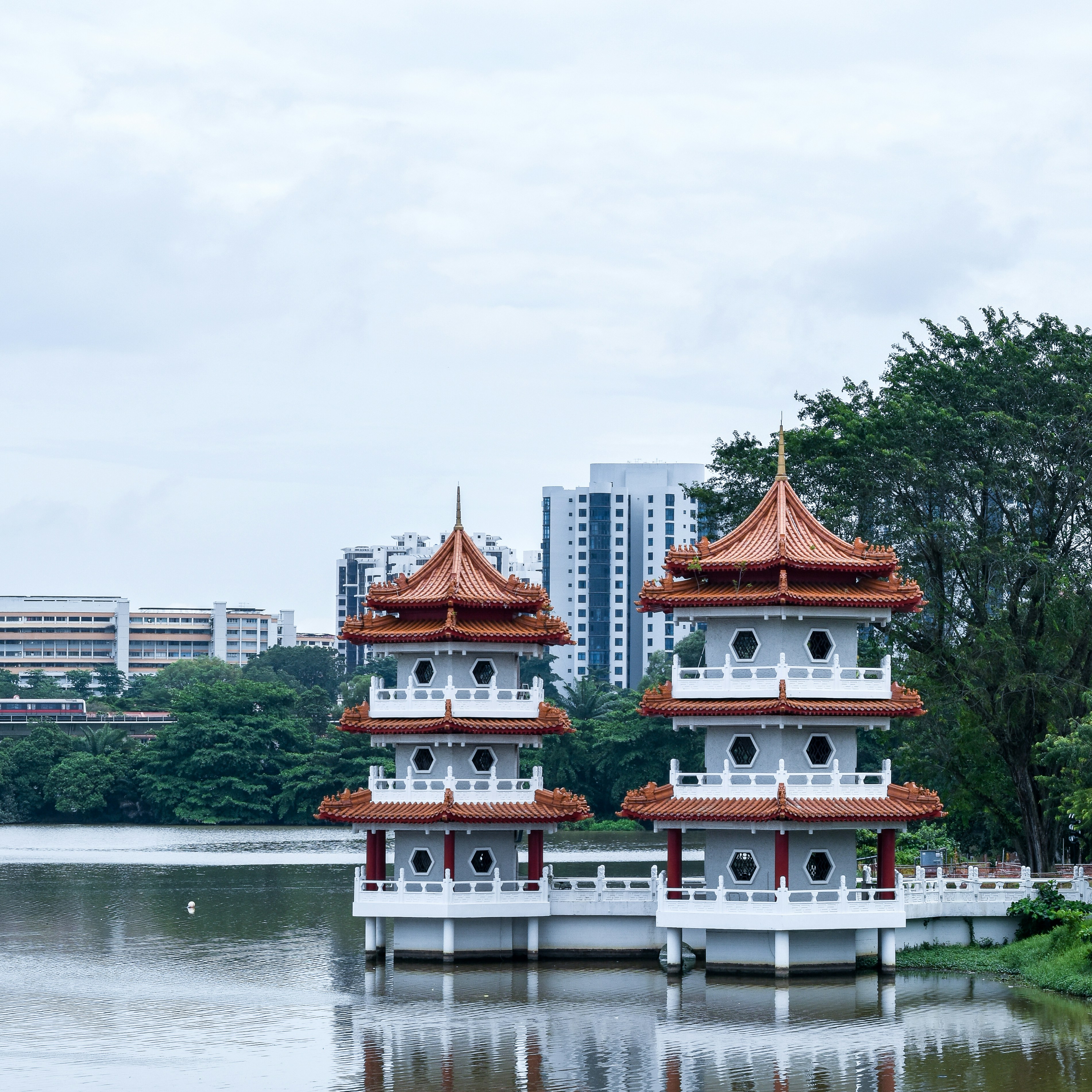 red and white concrete building near body of water during daytime