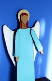 3D LED angel figure casting gentle shadows on a white wall.