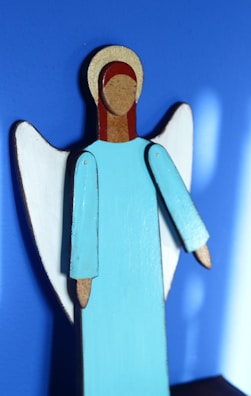 3D LED angel figure casting gentle shadows on a white wall.