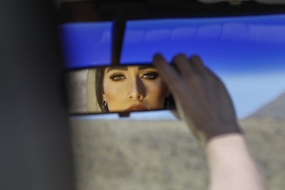 Close-up of a driver checking the wing mirror before starting a long-haul journey.