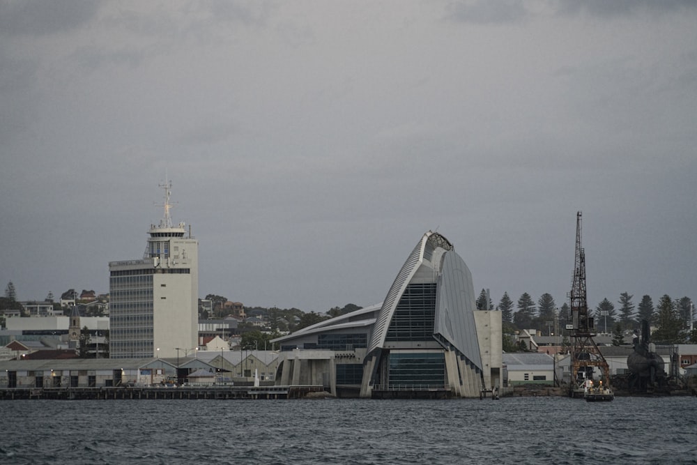 white and blue concrete building near body of water during daytime