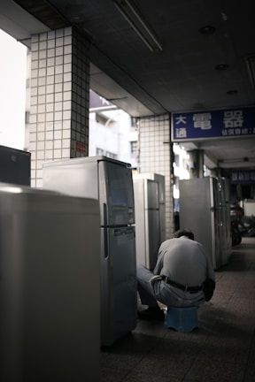 person in white long sleeve shirt sitting on chair