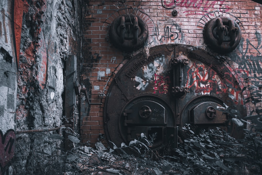 black and red brick wall with graffiti