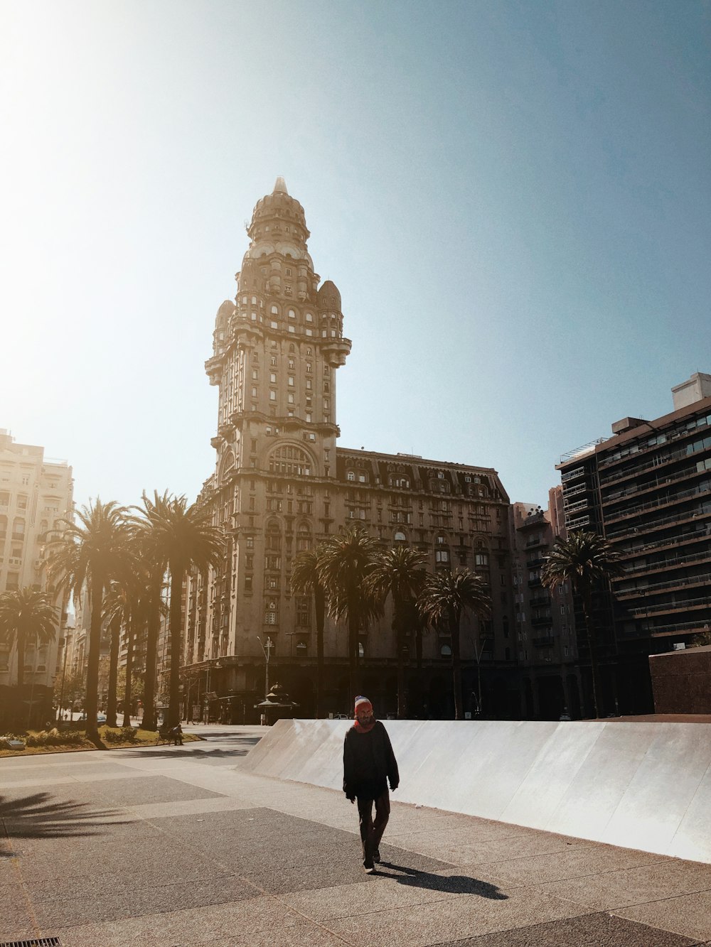 man in black jacket walking on street during daytime