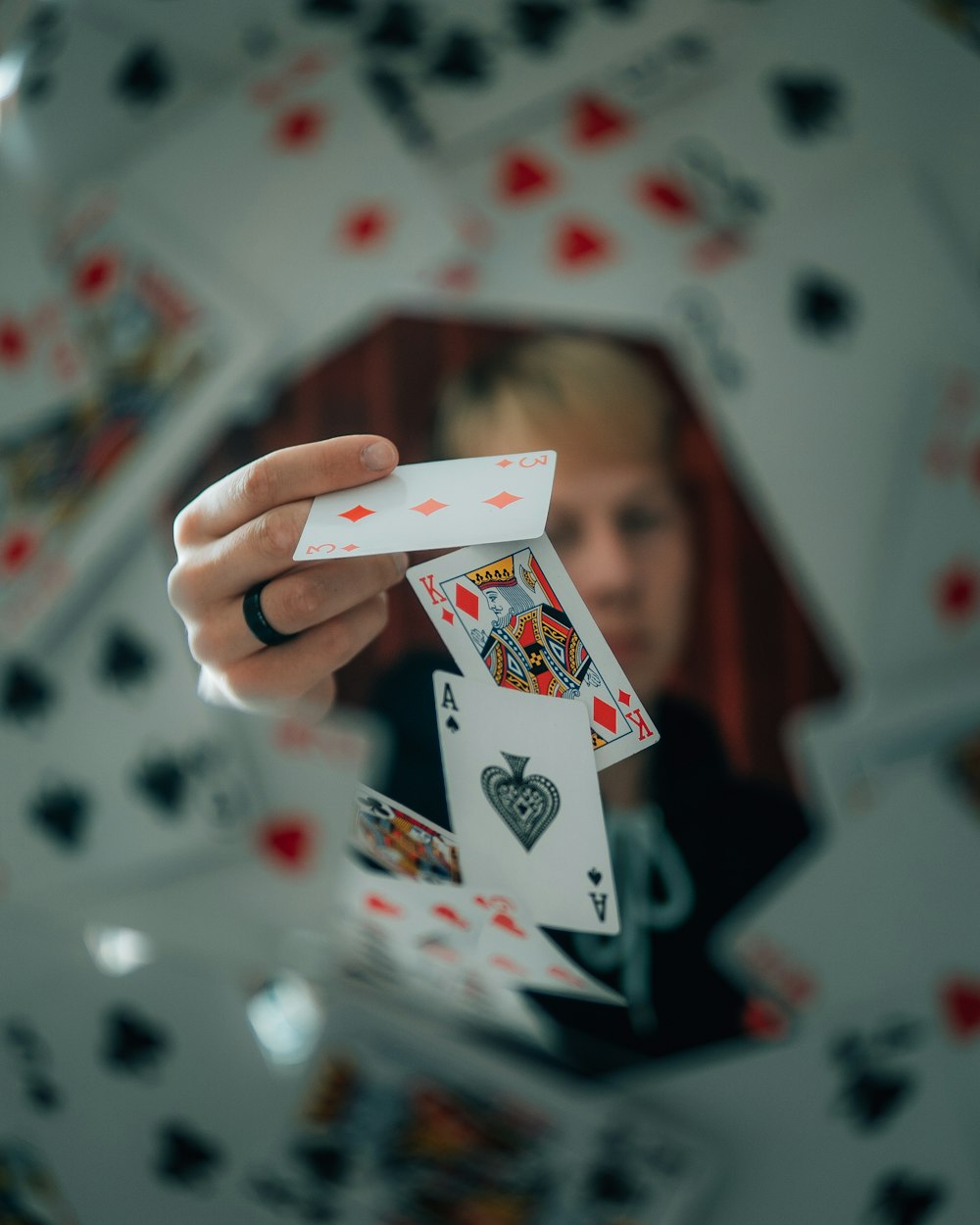 person holding a heart playing card