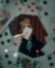 person holding 2 of diamonds playing card