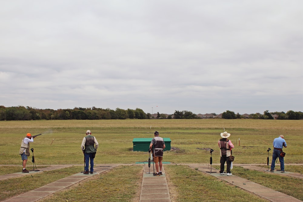 people walking on green grass field during daytime